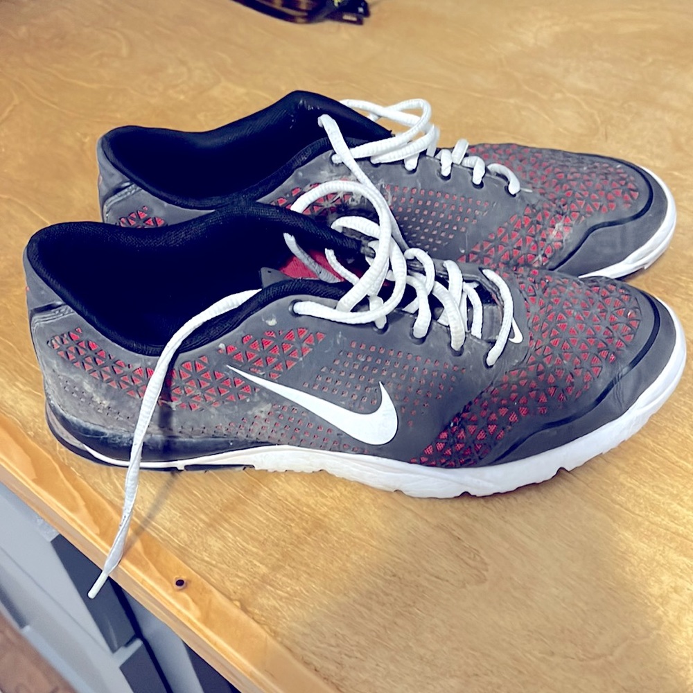 Red and dark grey Nike golf shoes